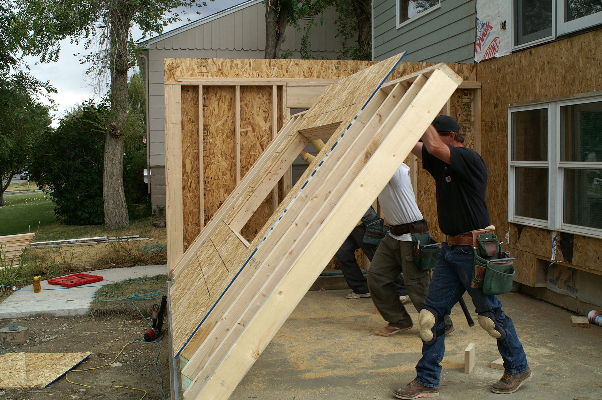 men constructing a home addition